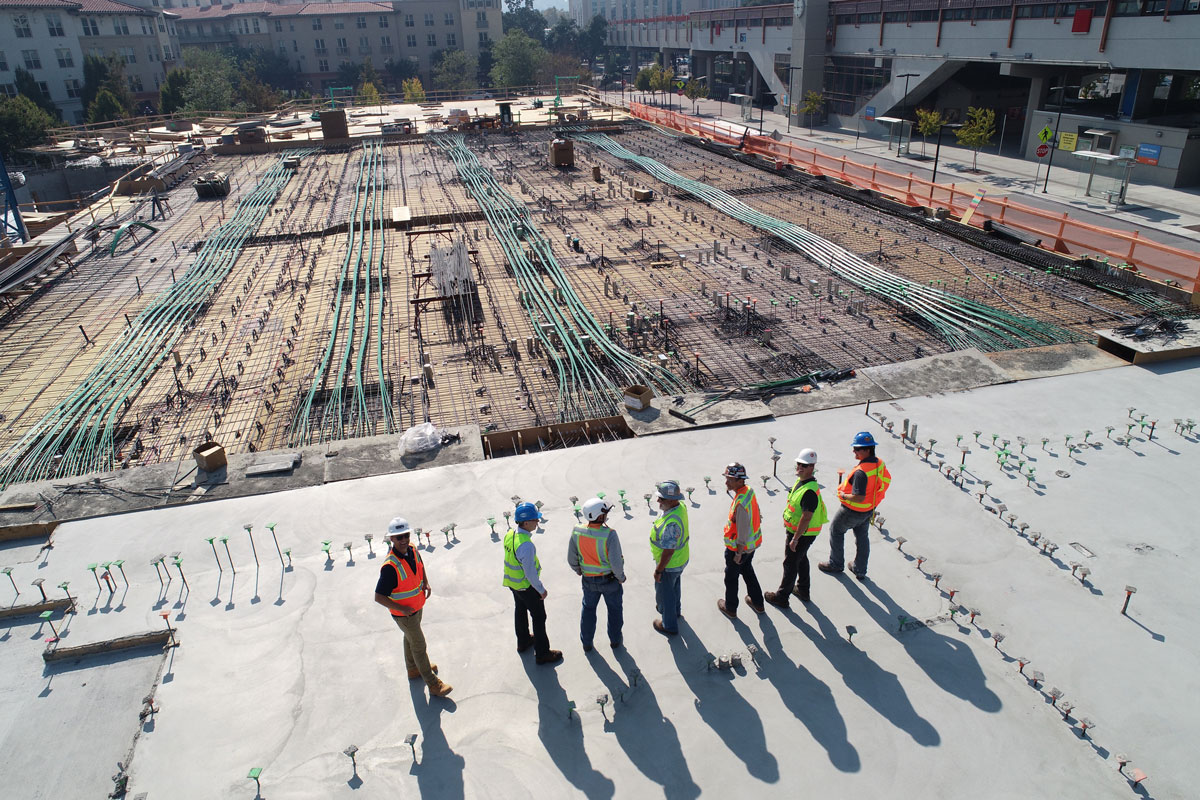 Engineers and Construction Workers on Roof